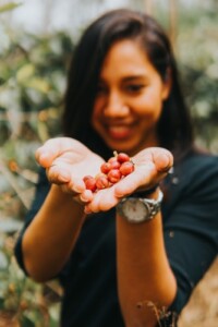 Woman holding coffee beans 